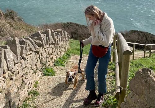 Zoe with her foster dog Buttercup out on a coastal walk