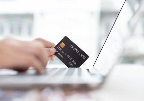 Shopping online with laptop and credit card