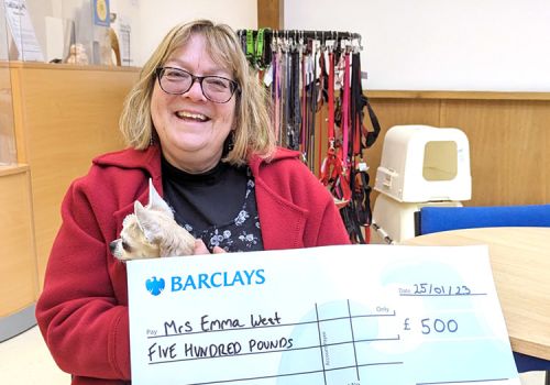 Woman collecting raffle prize with big cheque