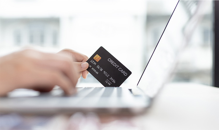 Shopping online with laptop and credit card 