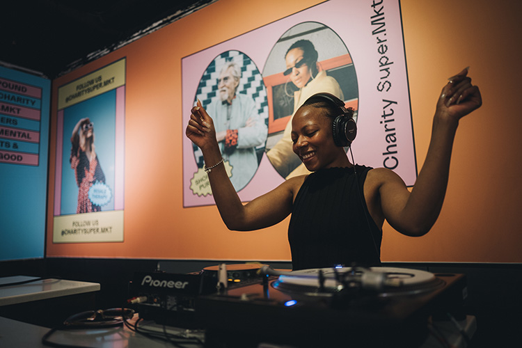 Woman DJing in store at Charity Super Mkt