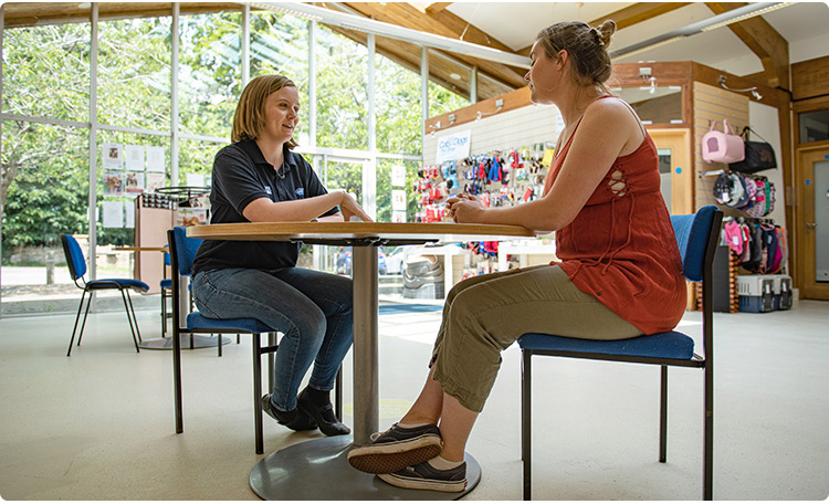 Rehomer staff talking to adopter in our reception area