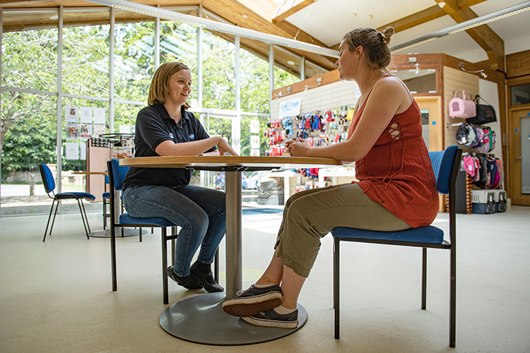 Staff and member of the public chatting in the reception area